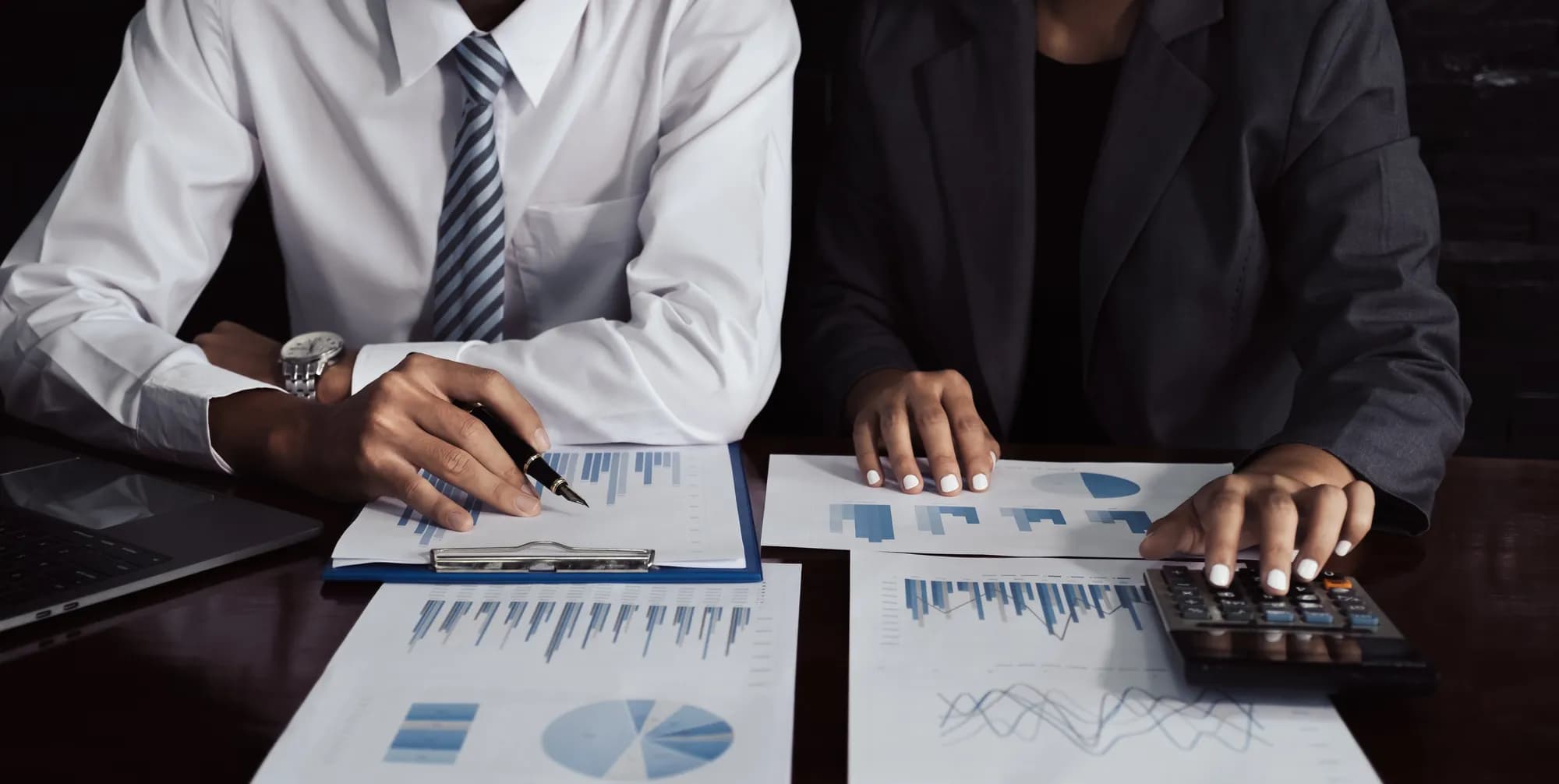 Finance colleagues reviewing performance dashboards